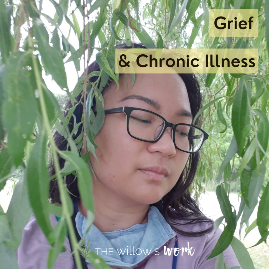 A hilariously moody image of Kaia, an Asian woman with rectangular glasses, among willow fronds. Yellow blocks in the top right underline grey text reading, “Grief & chronic illness.” ⁣